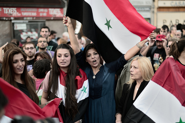 Heroic people waving Syrian flag